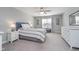 Bright bedroom with soft carpet, large window, and a bed with a padded headboard, offering comfort and style at 622 Ehrlich Ln, Westfield, IN 46074