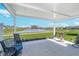 Charming covered patio with seating, overlooking a scenic pond and lush green lawns, perfect for outdoor enjoyment at 622 Ehrlich Ln, Westfield, IN 46074