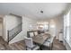 Open-concept view of the dining room, staircase, and kitchen area with an island at 622 Ehrlich Ln, Westfield, IN 46074