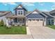 Charming blue two-story home with a two-car garage and inviting front porch at 622 Ehrlich Ln, Westfield, IN 46074