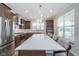 Modern kitchen featuring a large center island with seating, stainless appliances and pendant lighting at 622 Ehrlich Ln, Westfield, IN 46074