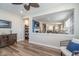 Open-concept living room with wood floors, neutral decor, and a view of the staircase, kitchen, and dining areas at 622 Ehrlich Ln, Westfield, IN 46074