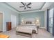 Comfortable main bedroom with tray ceiling, soft color scheme, night stands and reading lamps at 622 Ehrlich Ln, Westfield, IN 46074