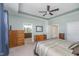 Open main bedroom leading to bathroom and closet space featuring a large bed and dresser at 622 Ehrlich Ln, Westfield, IN 46074