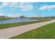 Scenic pond view with a walking path, surrounded by green lawns and residential homes, offering a peaceful atmosphere at 622 Ehrlich Ln, Westfield, IN 46074