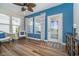 Bright sunroom with wood floors, neutral decor, and ample natural light from many windows with backyard views at 622 Ehrlich Ln, Westfield, IN 46074