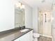 Bathroom with tile shower, glass door, a large countertop, and bright lighting at 64 Central Greens Blvd, Indianapolis, IN 46222