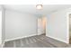The bedroom has neutral walls, carpet, and a sliding door to another room in the house at 64 Central Greens Blvd, Indianapolis, IN 46222