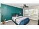 Bedroom with a dark accent wall, ceiling fan, window with blinds, and carpeted floors at 64 Central Greens Blvd, Indianapolis, IN 46222