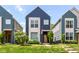 Charming blue two-story home with manicured lawn and front garden at 64 Central Greens Blvd, Indianapolis, IN 46222