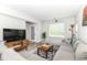 Cozy living room with gray sectional sofa and lots of natural light at 64 Central Greens Blvd, Indianapolis, IN 46222