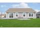 The home's backyard features a concrete patio, well-kept lawn, and neutral vinyl siding at 6467 W Whispering N Way, Greenfield, IN 46140