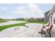 A scenic backyard featuring a concrete patio, lush lawn, and views of neighborhood homes at 6467 W Whispering N Way, Greenfield, IN 46140
