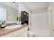A bathroom featuring a vanity and a shower-tub combo with white tile surround at 6467 W Whispering N Way, Greenfield, IN 46140