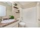 A bathroom featuring a vanity and a shower-tub combo with white tile surround and shelving at 6467 W Whispering N Way, Greenfield, IN 46140