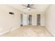 A spacious bedroom with neutral carpet, a ceiling fan and doors to an ensuite bath and closet at 6467 W Whispering N Way, Greenfield, IN 46140