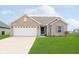 Well-maintained single-Gathering home with a two-car attached garage and manicured lawn at 6467 W Whispering N Way, Greenfield, IN 46140