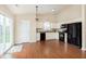 Bright eat-in kitchen with updated appliances, countertops and hardwood floors, plus modern light fixtures at 6467 W Whispering N Way, Greenfield, IN 46140