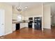 Bright kitchen with updated countertops and flooring featuring black appliances and modern light fixtures at 6467 W Whispering N Way, Greenfield, IN 46140