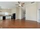 Spacious living room with hardwood floors, ceiling fan and an open layout kitchen at 6467 W Whispering N Way, Greenfield, IN 46140