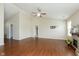 Living room featuring an open layout, hardwood floors, and a cozy stone fireplace at 6467 W Whispering N Way, Greenfield, IN 46140