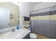 Bright bathroom with a single sink vanity and a toilet with a shower curtain at 6535 Heben Ct, Indianapolis, IN 46113