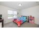 Carpeted bedroom with a large window letting in natural light and bright decor at 6535 Heben Ct, Indianapolis, IN 46113