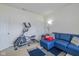 Comfortable bedroom with a blue couch, an exercise machine, and natural light at 6535 Heben Ct, Indianapolis, IN 46113