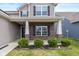 Inviting front porch with brick accents and manicured landscaping adds curb appeal at 6535 Heben Ct, Indianapolis, IN 46113