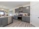 Modern kitchen features stainless steel appliances, gray cabinets, and hardwood floors at 6535 Heben Ct, Indianapolis, IN 46113