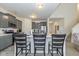 Modern kitchen with stainless steel appliances, gray cabinets, and a breakfast bar seating at 6535 Heben Ct, Indianapolis, IN 46113