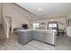 Open concept kitchen with gray cabinets, stainless steel appliances, and hardwood floors at 6535 Heben Ct, Indianapolis, IN 46113