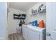 Efficient laundry room with updated appliances and storage shelves for cleaning and laundry supplies at 6535 Heben Ct, Indianapolis, IN 46113