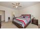 Well-lit main bedroom with carpet, ceiling fan, and an ensuite bathroom at 6535 Heben Ct, Indianapolis, IN 46113