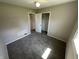 A light-filled bedroom showcases neutral walls and carpeting with a ceiling fan and closet at 6672 E 225 S, Whitestown, IN 46075