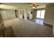 Open-concept living room with views to the kitchen and sliding doors to the backyard at 6672 E 225 S, Whitestown, IN 46075