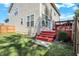 Large backyard with grass, the back of the house, and a red back deck at 6869 W Winding, McCordsville, IN 46055