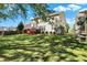 Large backyard with green grass and the back of the house and deck at 6869 W Winding, McCordsville, IN 46055