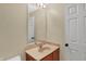 Standard bathroom with wood vanity, marble countertop, decorative mirror and white door at 6869 W Winding, McCordsville, IN 46055