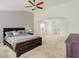 Bright bedroom with gray walls, dark furniture, and a ceiling fan at 6869 W Winding, McCordsville, IN 46055