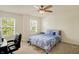 Bright bedroom with large windows, ceiling fan, and comfortable bed with patterned bedding at 6869 W Winding, McCordsville, IN 46055