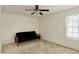 Neutral bedroom with a black futon, ceiling fan and a window with natural light at 6869 W Winding, McCordsville, IN 46055