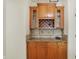 Butler's pantry featuring wooden cabinetry, granite counters, and a wine rack at 6869 W Winding, McCordsville, IN 46055