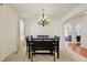 Dining room featuring wood floors, a chandelier, large windows, and neutral paint at 6869 W Winding, McCordsville, IN 46055