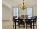 Dining room with modern chandelier, seating for six, and natural light from windows at 6869 W Winding, McCordsville, IN 46055