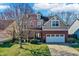Charming two-story home features a brick facade, dormer, and attached two car garage at 6869 W Winding, McCordsville, IN 46055