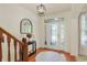Welcoming foyer features hardwood floors, elegant lighting, and decorative mirror at 6869 W Winding, McCordsville, IN 46055