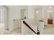 Bright hallway featuring a staircase with wood trim and an elegant hanging light fixture at 6869 W Winding, McCordsville, IN 46055