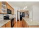 Classic kitchen with wood cabinets, granite counters, an island, and black appliances at 6869 W Winding, McCordsville, IN 46055