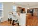 Kitchen featuring a breakfast bar with granite counters and comfortable seating at 6869 W Winding, McCordsville, IN 46055